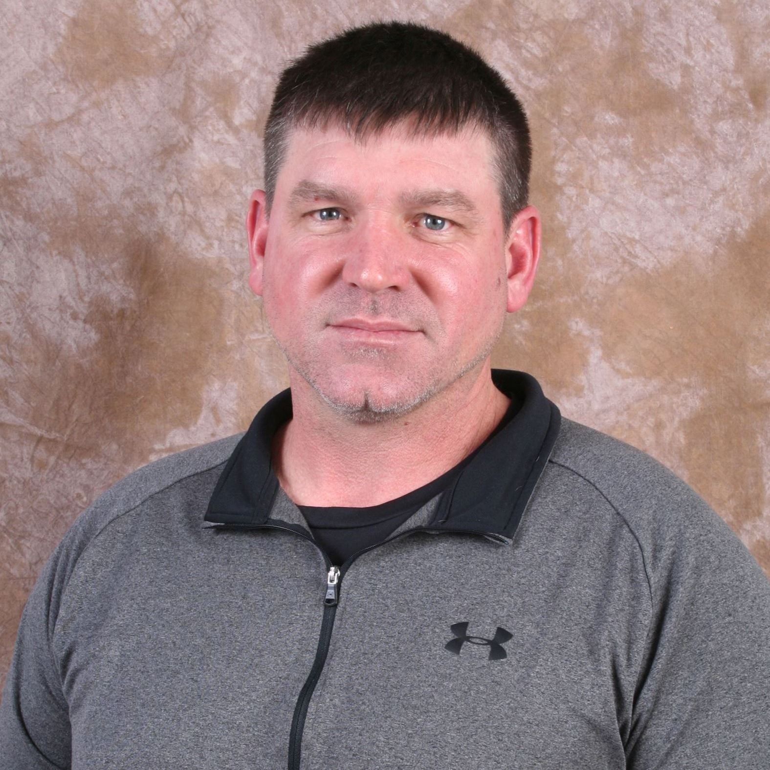 man in collared shirt sitting